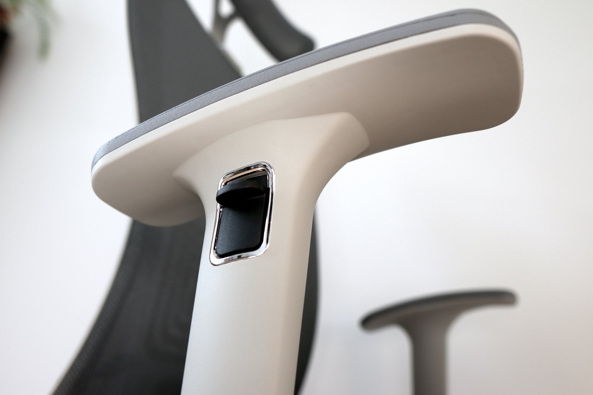 Modern office chair adjustable armrest control closeup