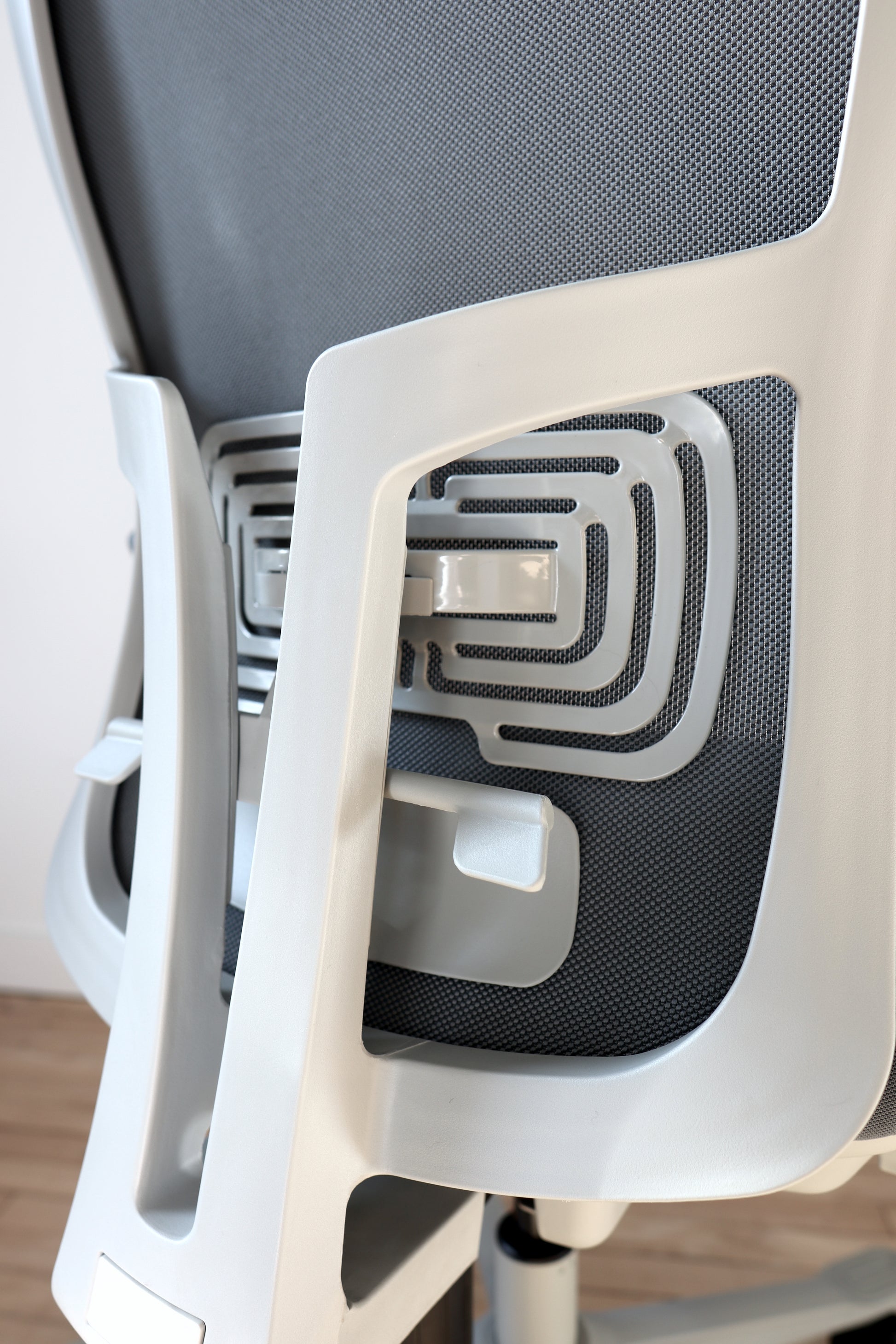 Dark grey office chair adjustable lumbar support closeup