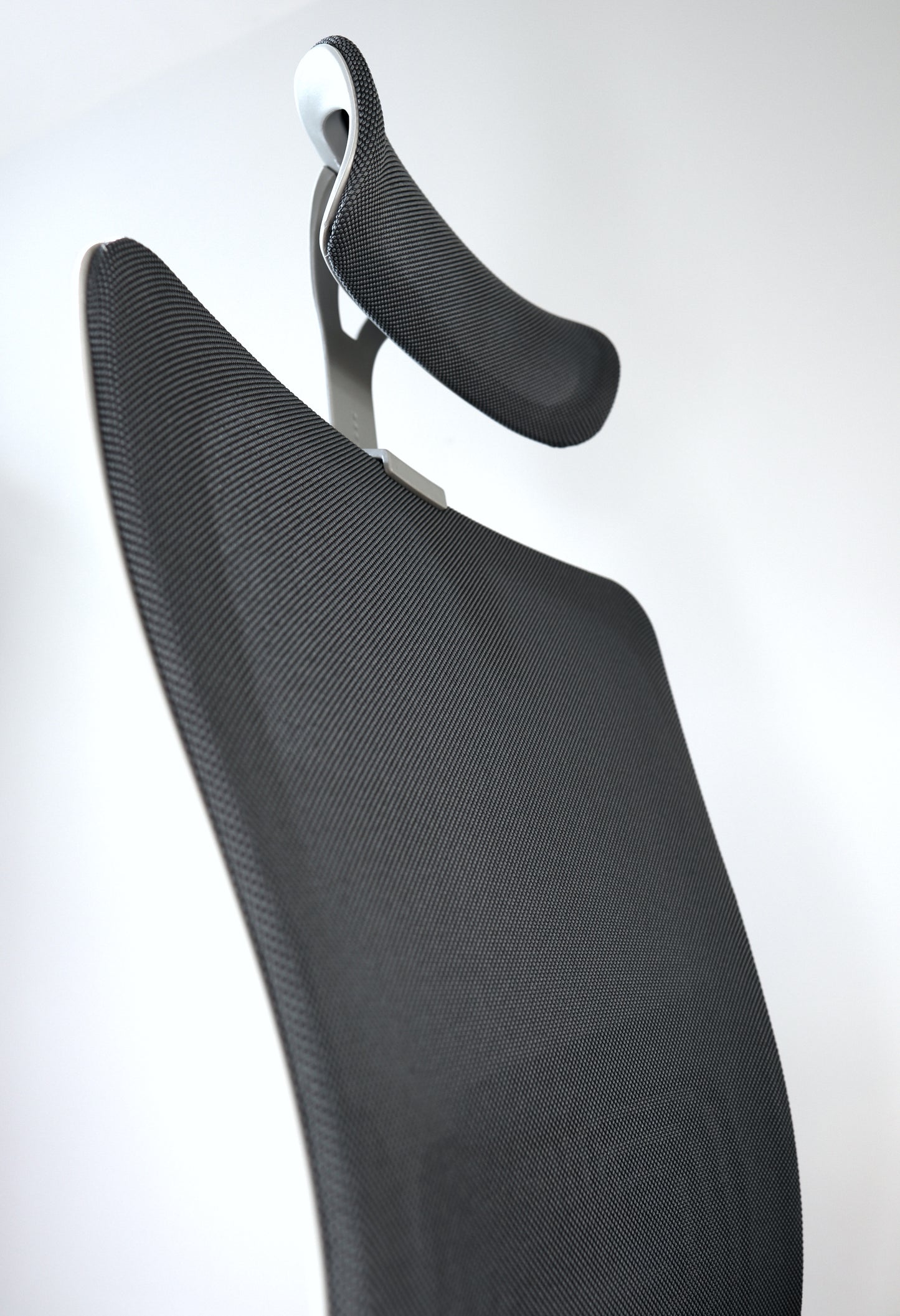 Dark grey office chair with curvy modern design and photo angle