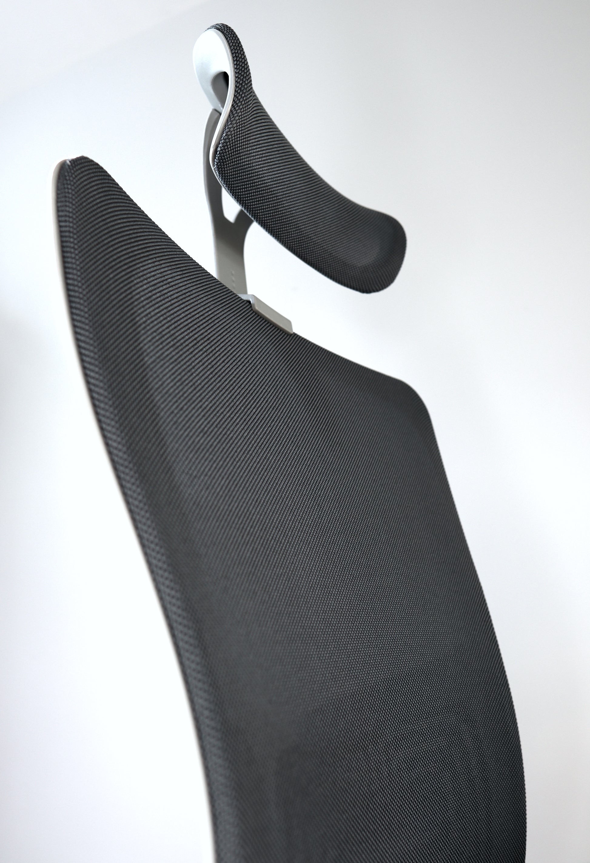 Dark grey office chair with curvy modern design and photo angle