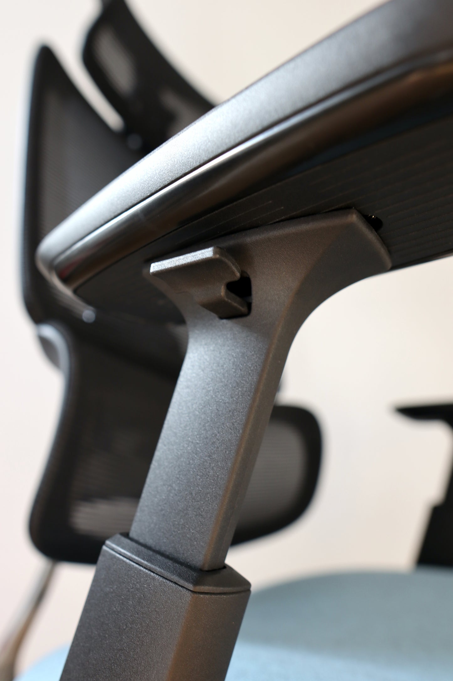 Closeup of office chair Triton adjustable armrest switch