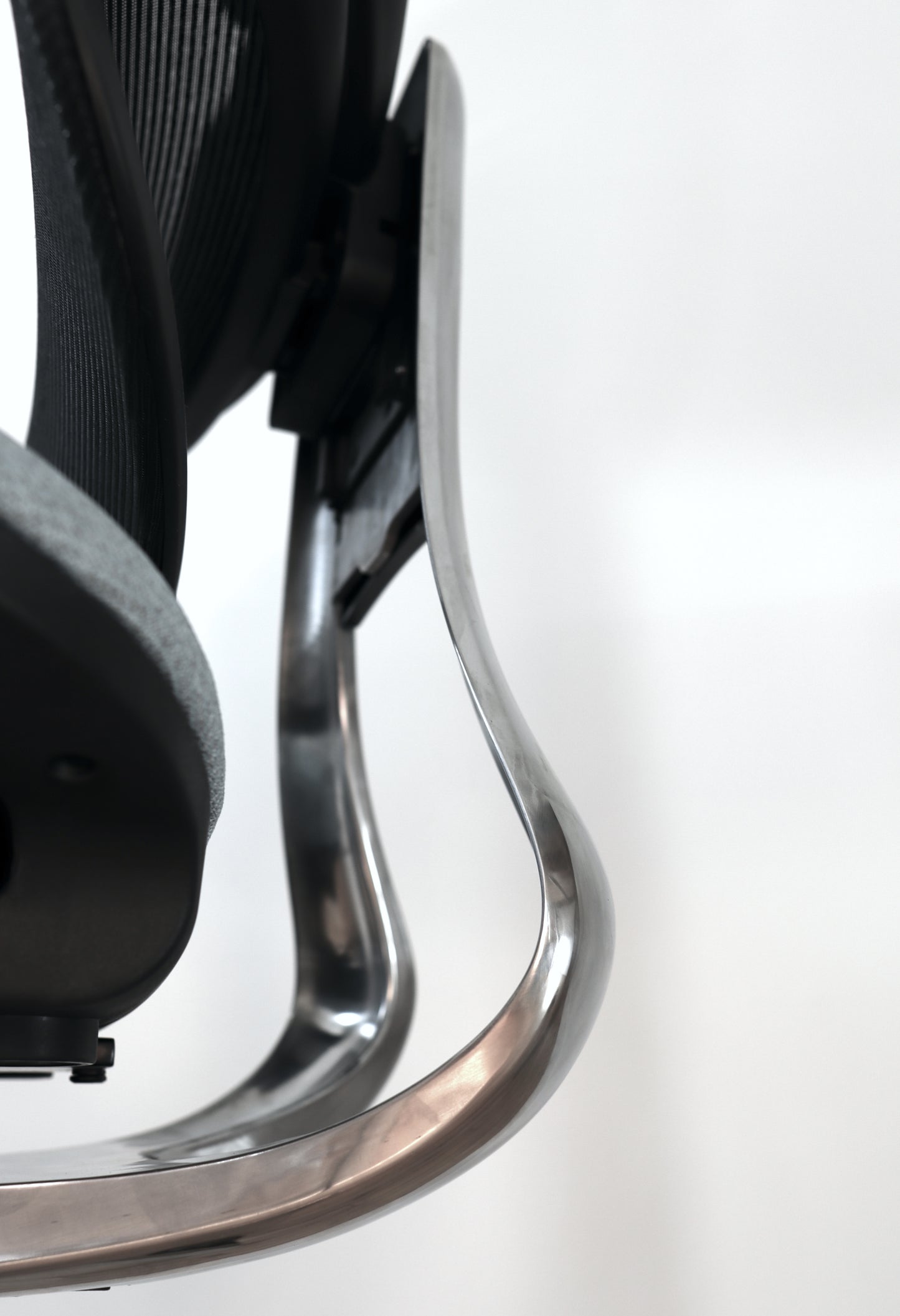 Closeup of Triton office chair shiny aluminum steel back support