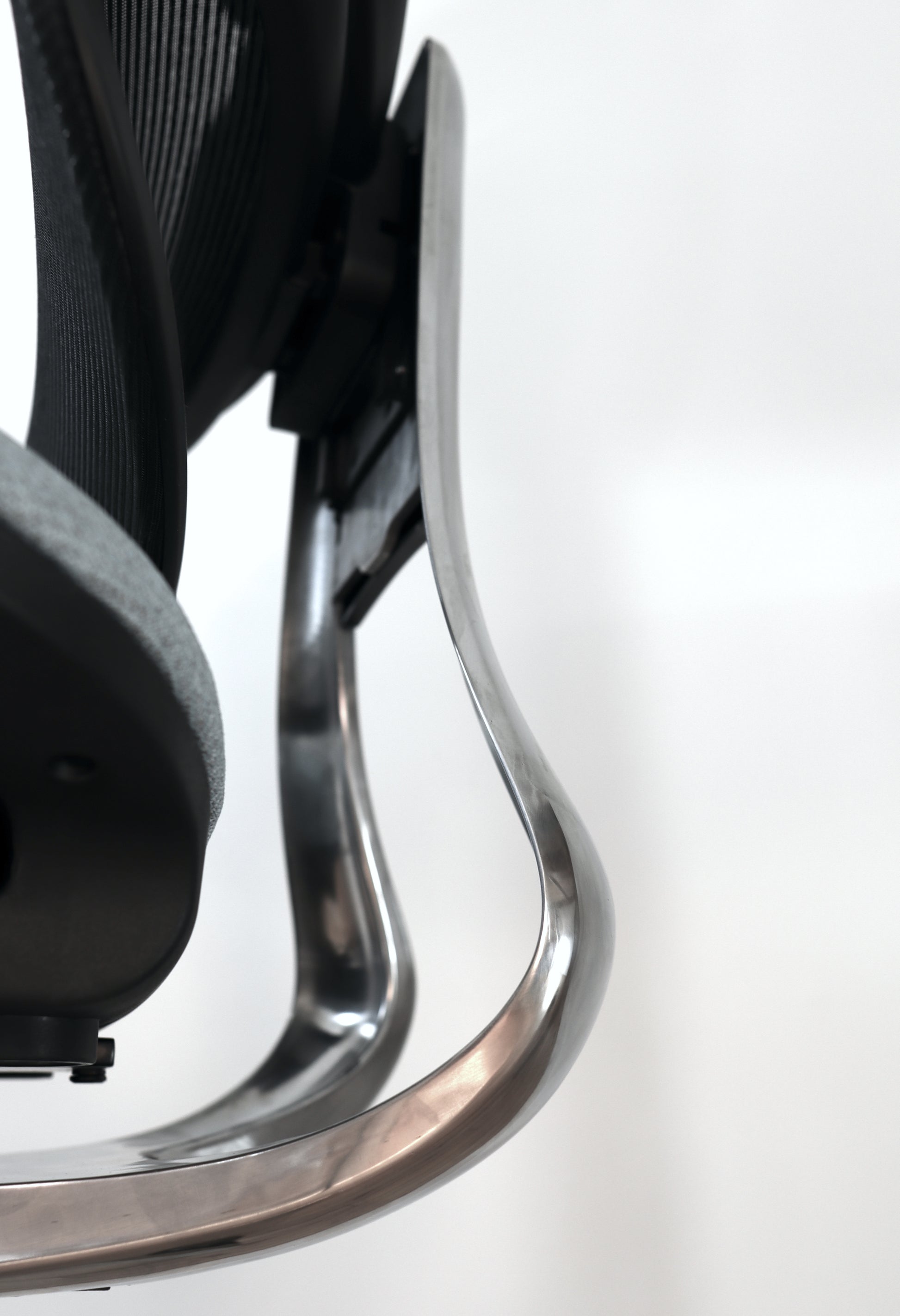 Closeup of Triton office chair shiny aluminum steel back support