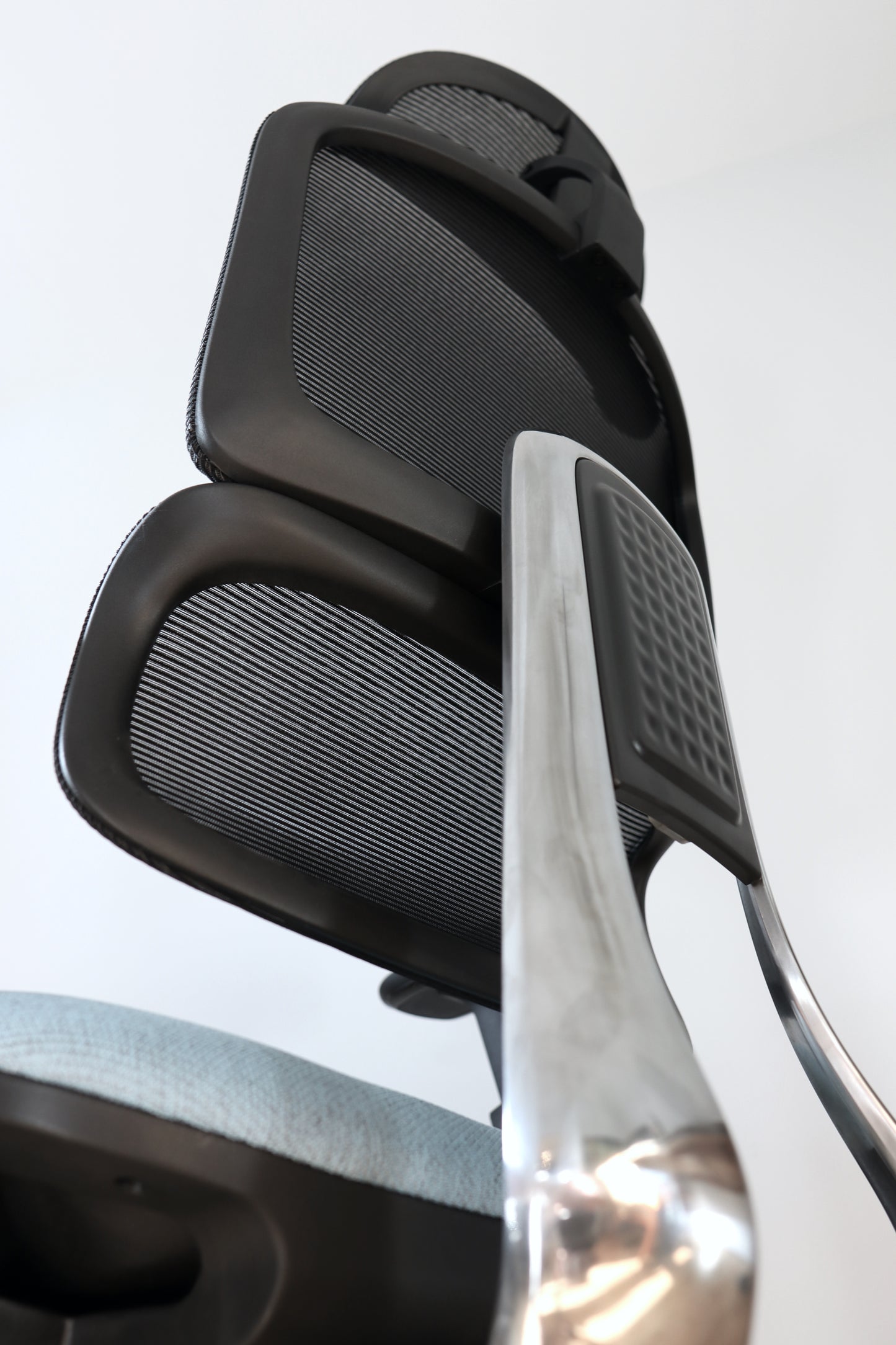 Closeup of Triton office chair shiny metal aluminum steel support