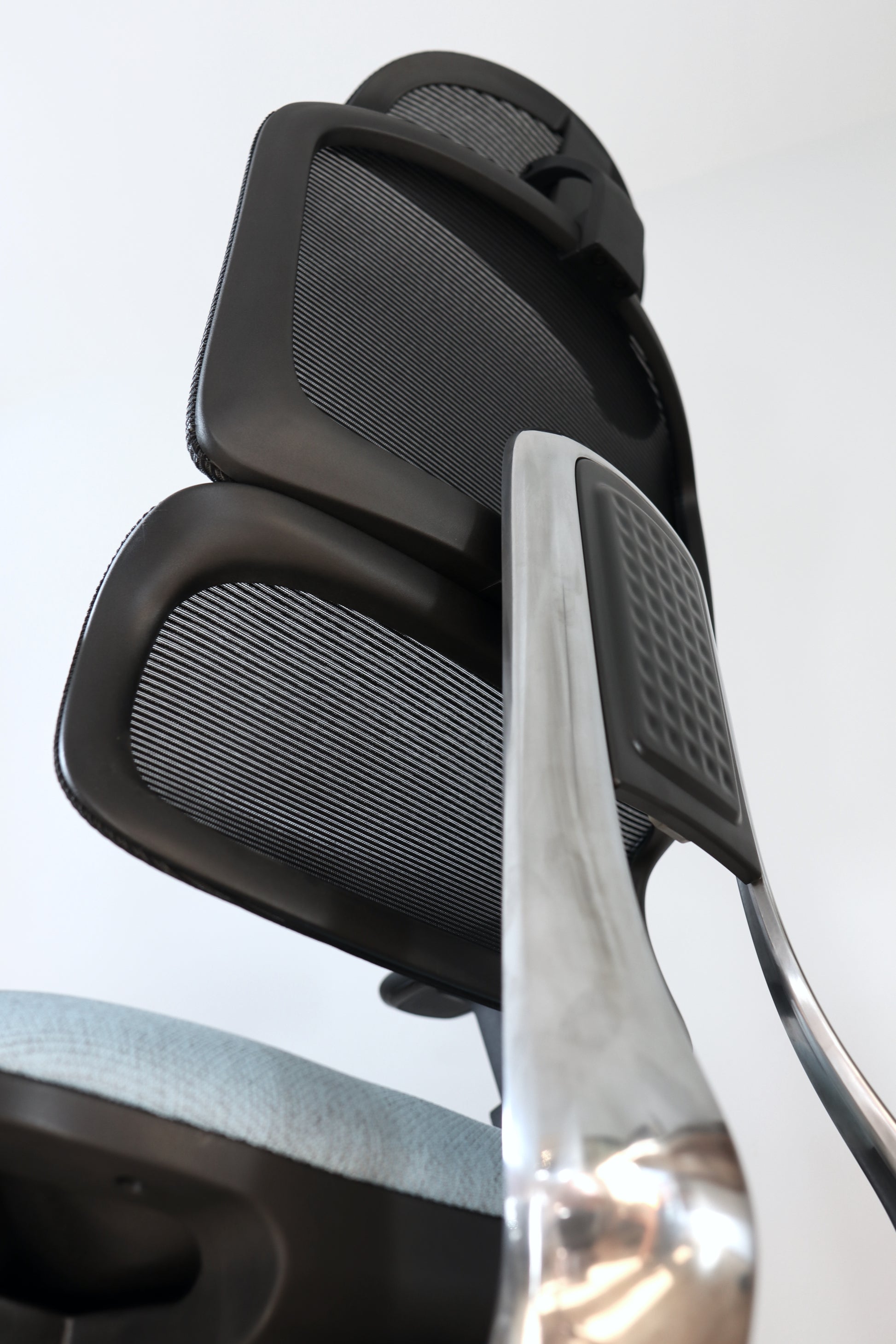 Closeup of Triton office chair shiny metal aluminum steel support