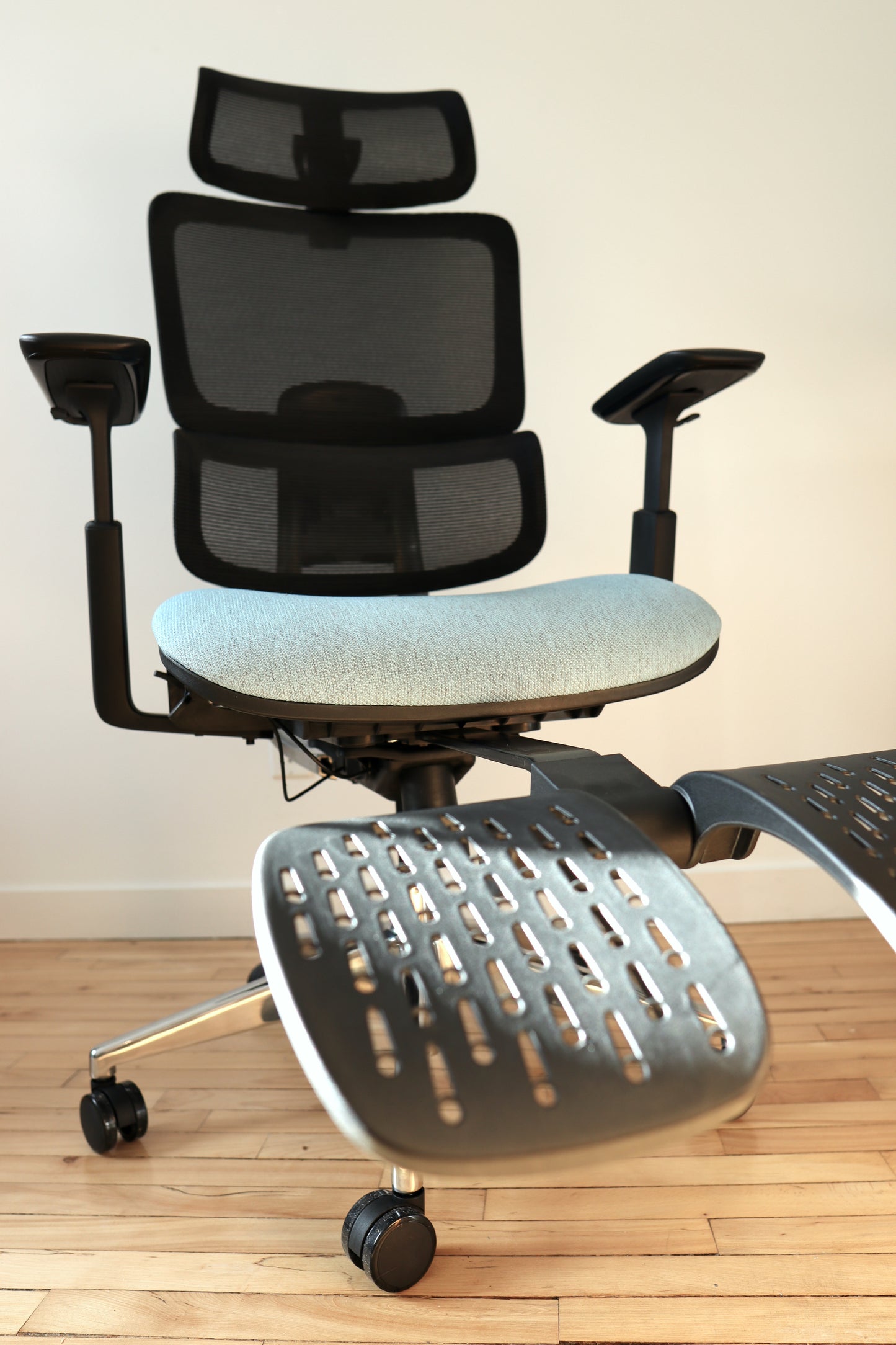 Blue office chair Triton with footrest extended in sunlight closeup