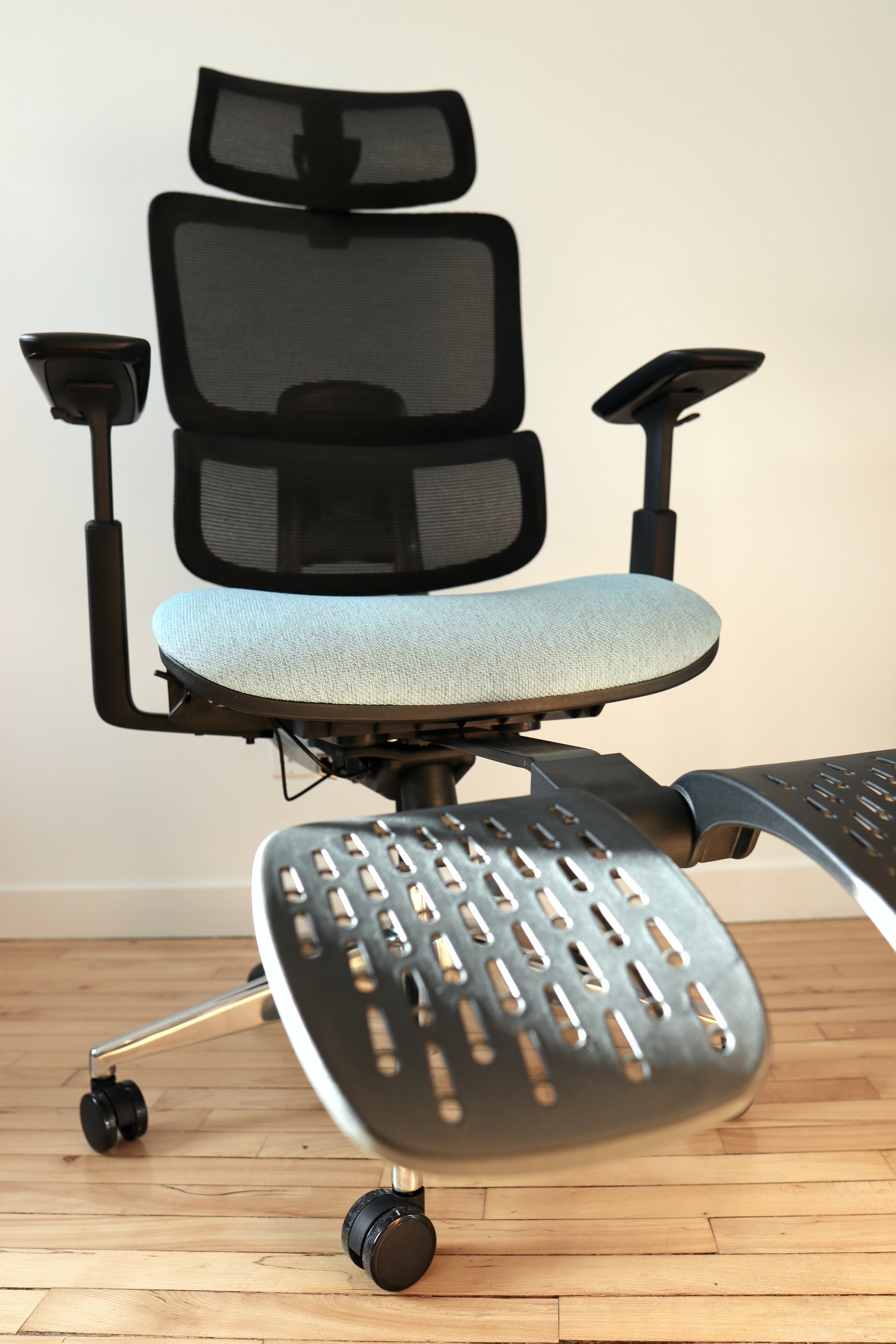 Blue office chair Triton with footrest extended in sunlight closeup